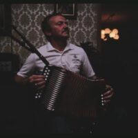 Man playing button accordion in franco-american band recording session in Dracut, Massachusetts, 1987.